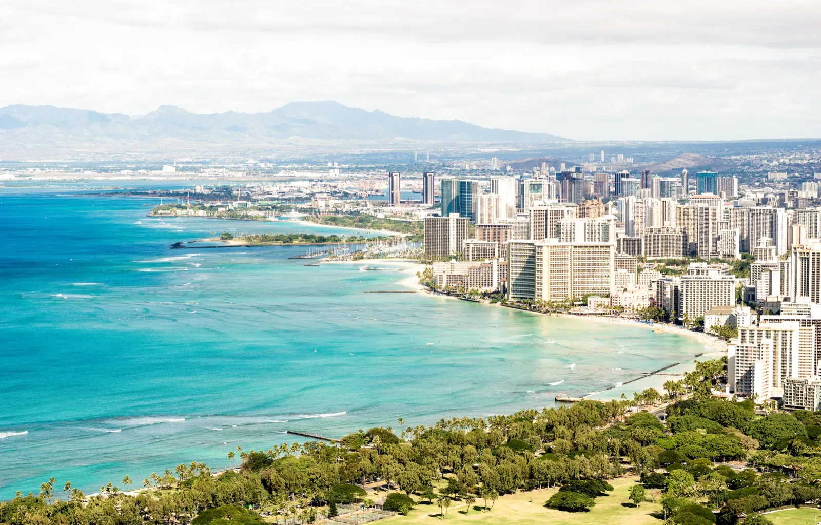 Romantic couple enjoying waikiki beach & ocean romance in Honolulu - perfect date planning destination with stunning city views and intimate atmosphere
