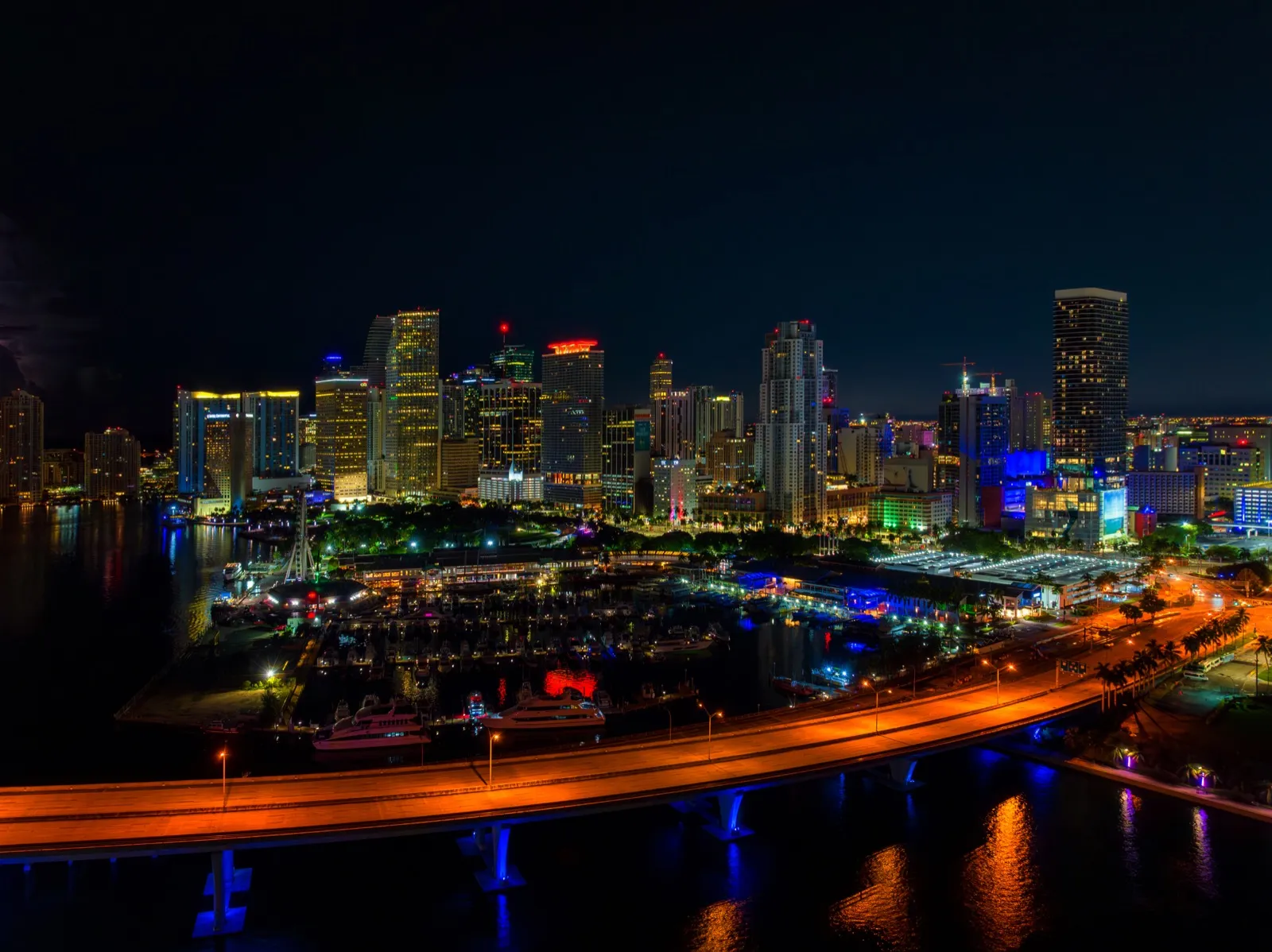 Miami Beach and Biscayne Bay glowing at night, seen from a couples helicopter tour