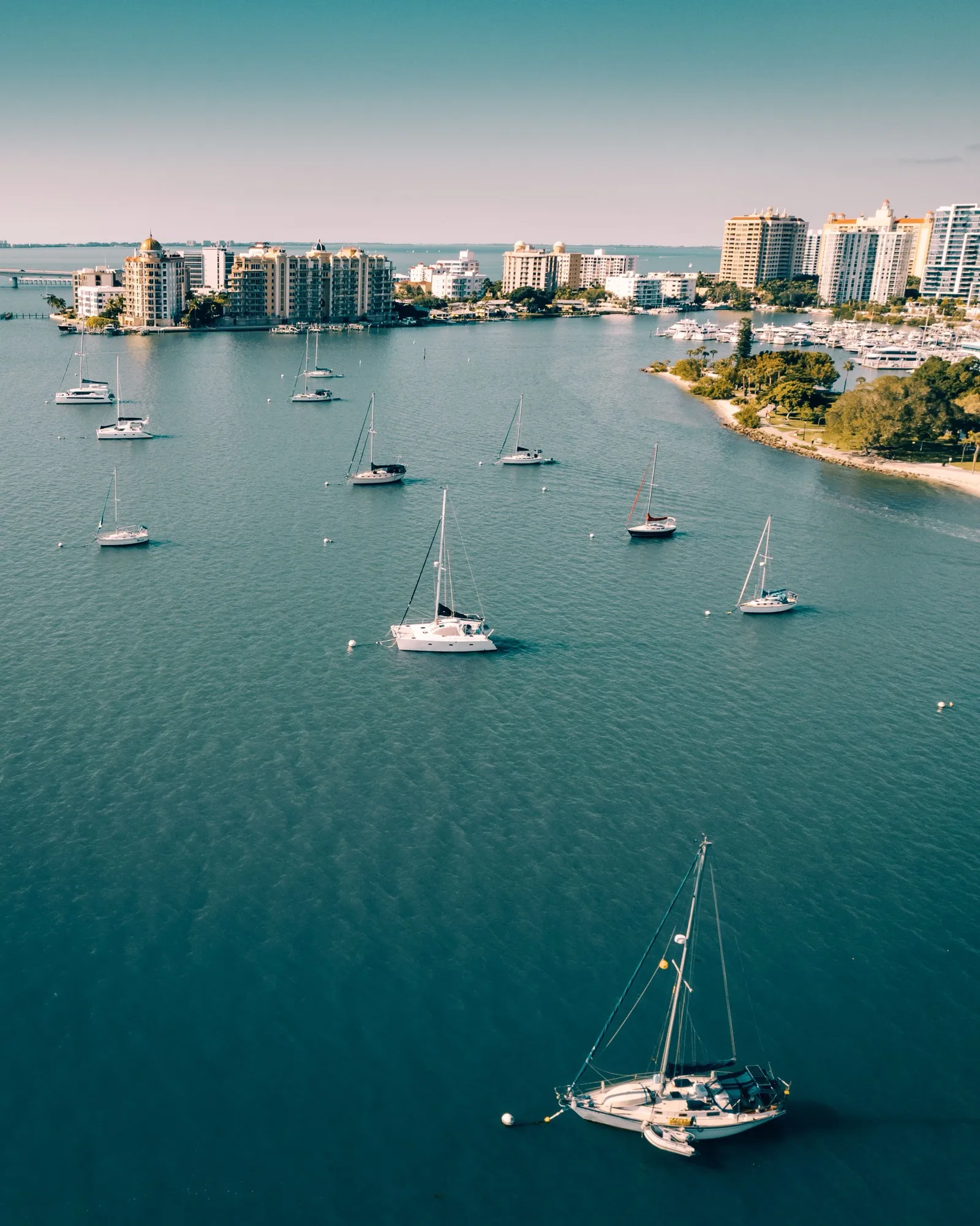 Couple's aerial view of white yachts sailing turquoise Biscayne Bay waters near downtown Miami