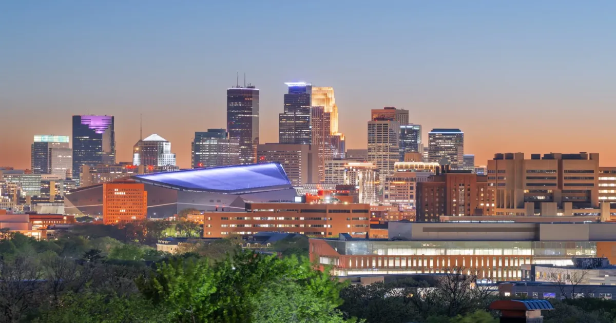 Minneapolis Minnesota skyline at dusk with Stone Arch Bridge and Mississippi River
