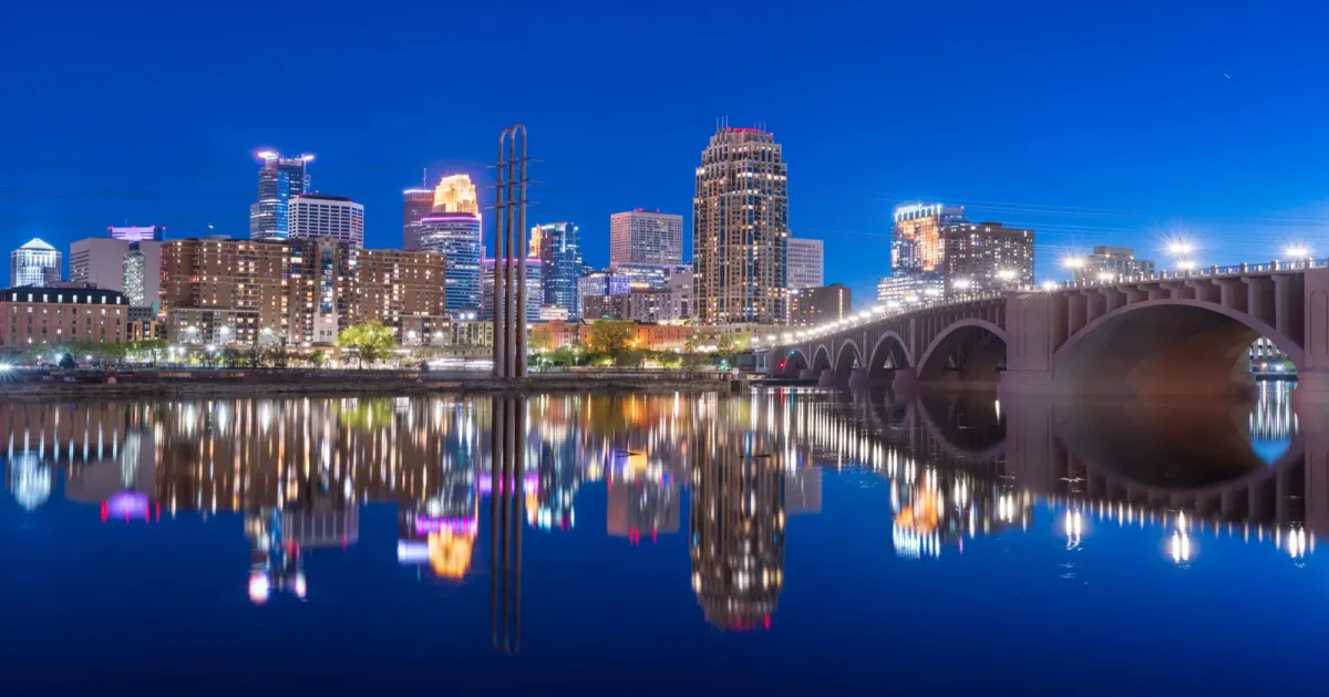 Stone Arch Bridge crossing the Mississippi River with Minneapolis skyline at sunset