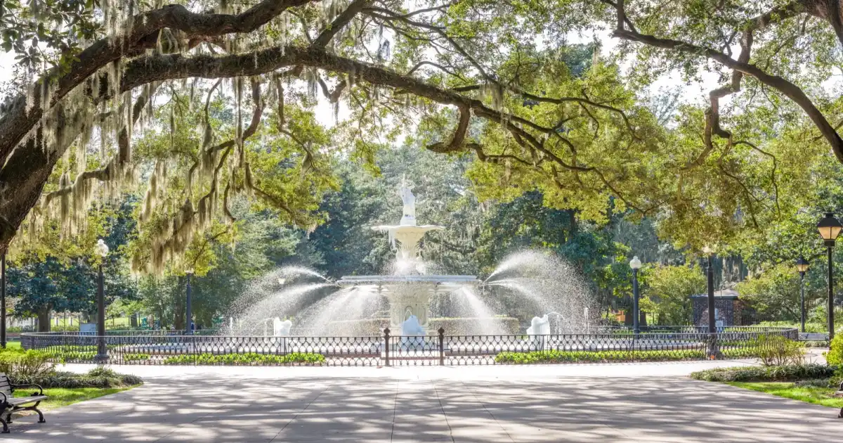 The iconic white Forsyth Park fountain surrounded by live oaks and Spanish moss