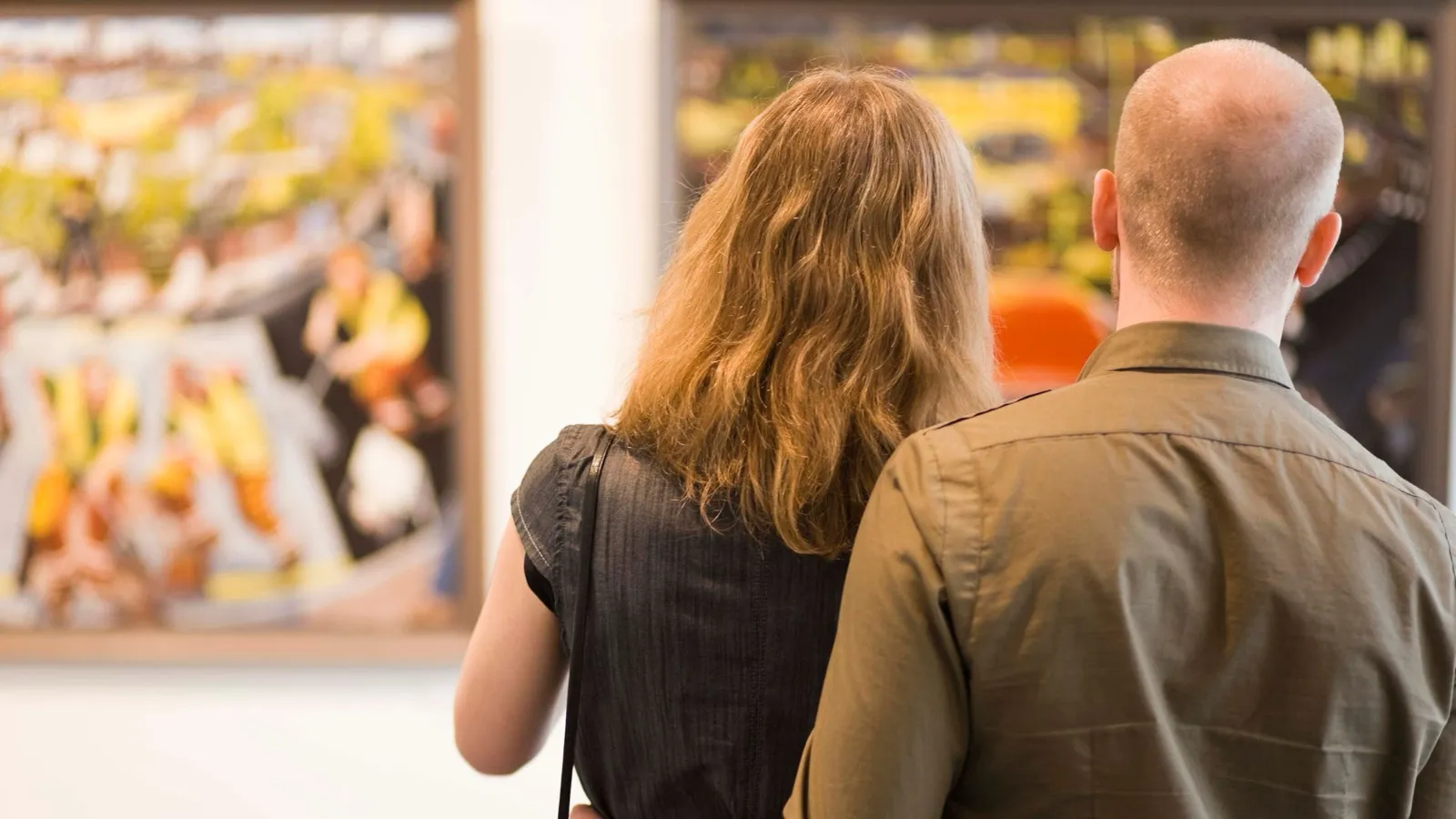 Romantic art gallery with couple viewing art