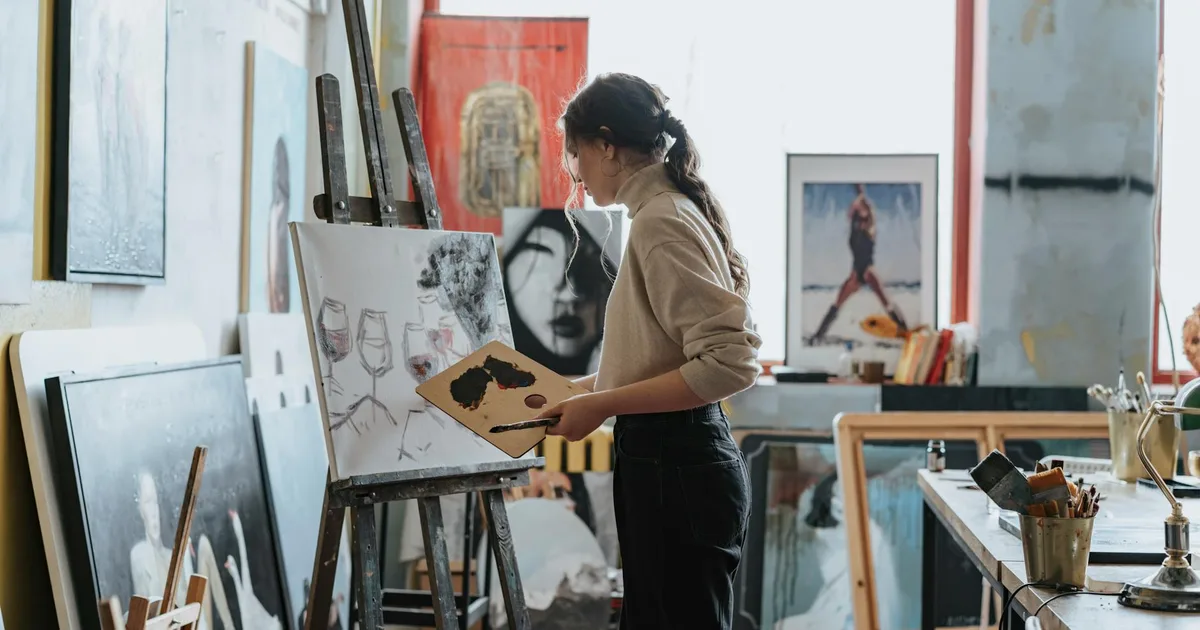 Couple painting together at sip and paint class - creative anniversary gift idea