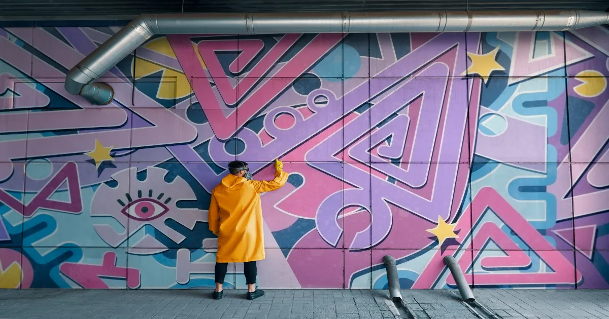 Couple walking through the colorful graffiti of Krog Street Tunnel