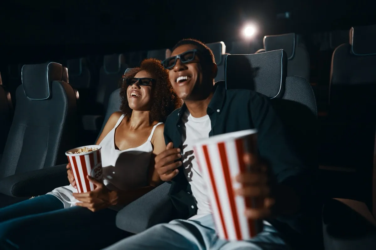 Couple at Alamo Drafthouse movie theater with popcorn NYC date night