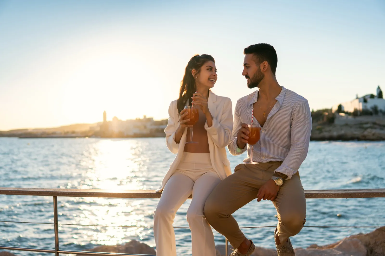 Couple enjoying cocktails at a rooftop bar overlooking downtown Dallas