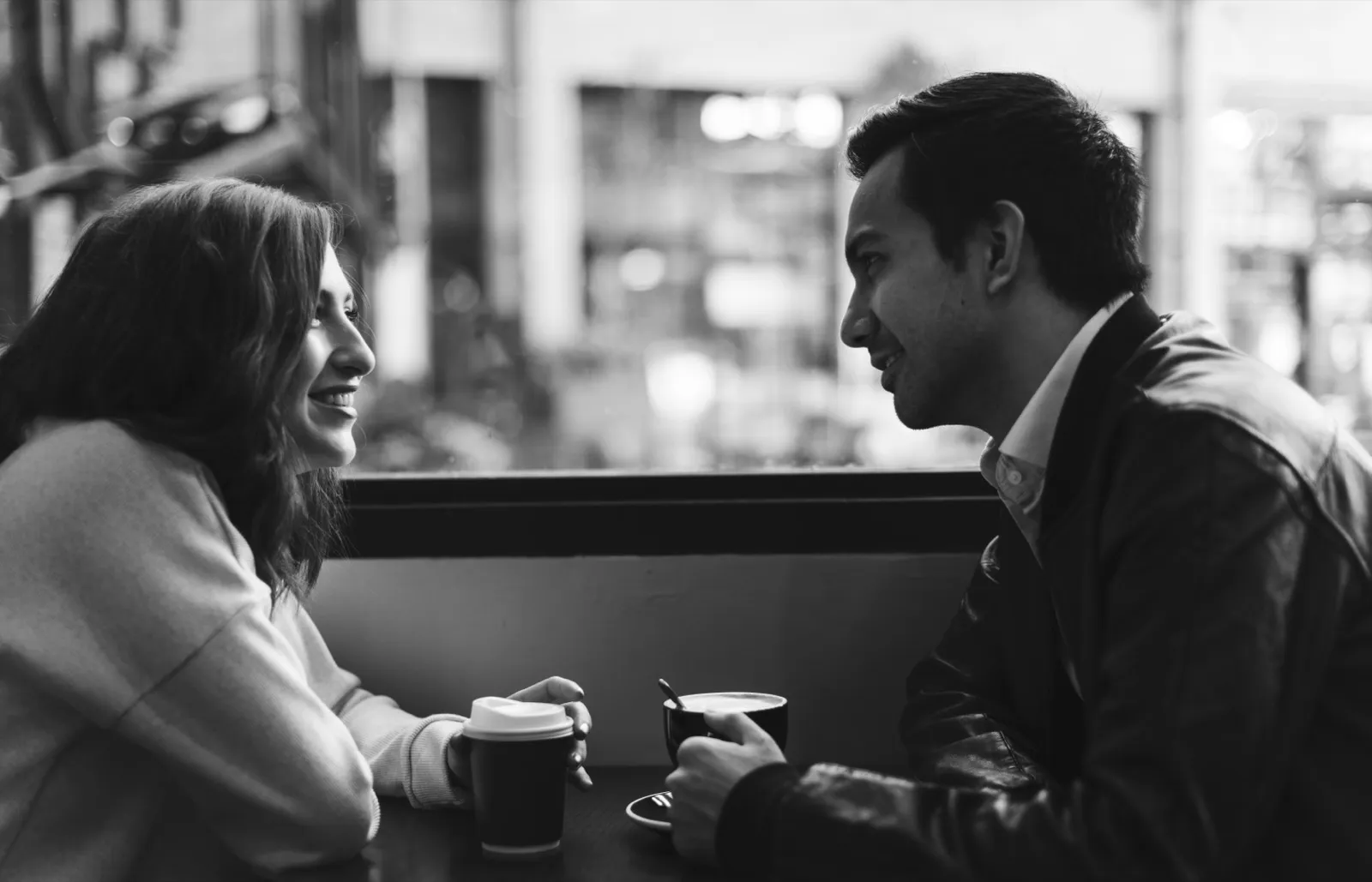 Couple enjoying coffee at a cafe on a budget date