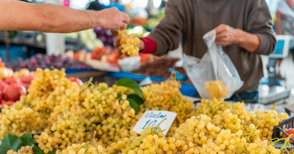 Couple browsing fresh produce and artisan foods at Dallas Farmers Market