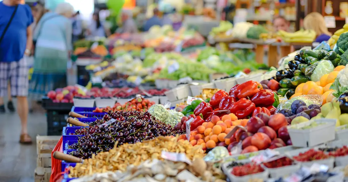 Couple tasting fresh produce and local goods at the Pearl Farmers Market