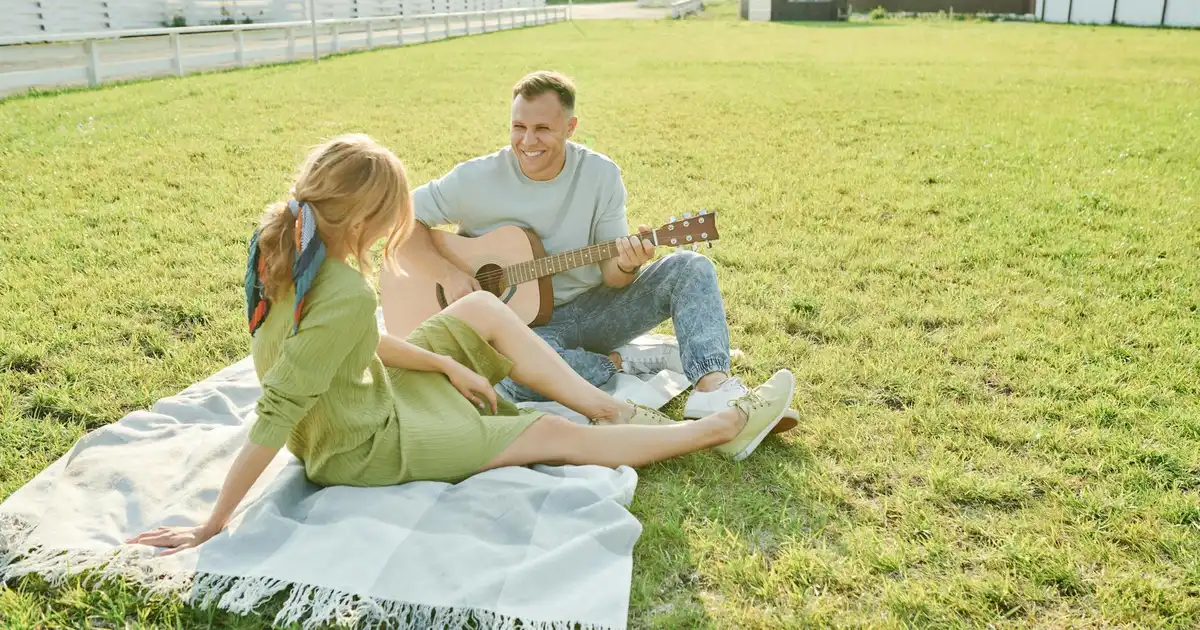 Couples sharing food at outdoor potluck picnic date