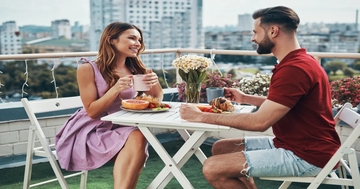 Couple enjoying rooftop dining with Chicago skyline and river views