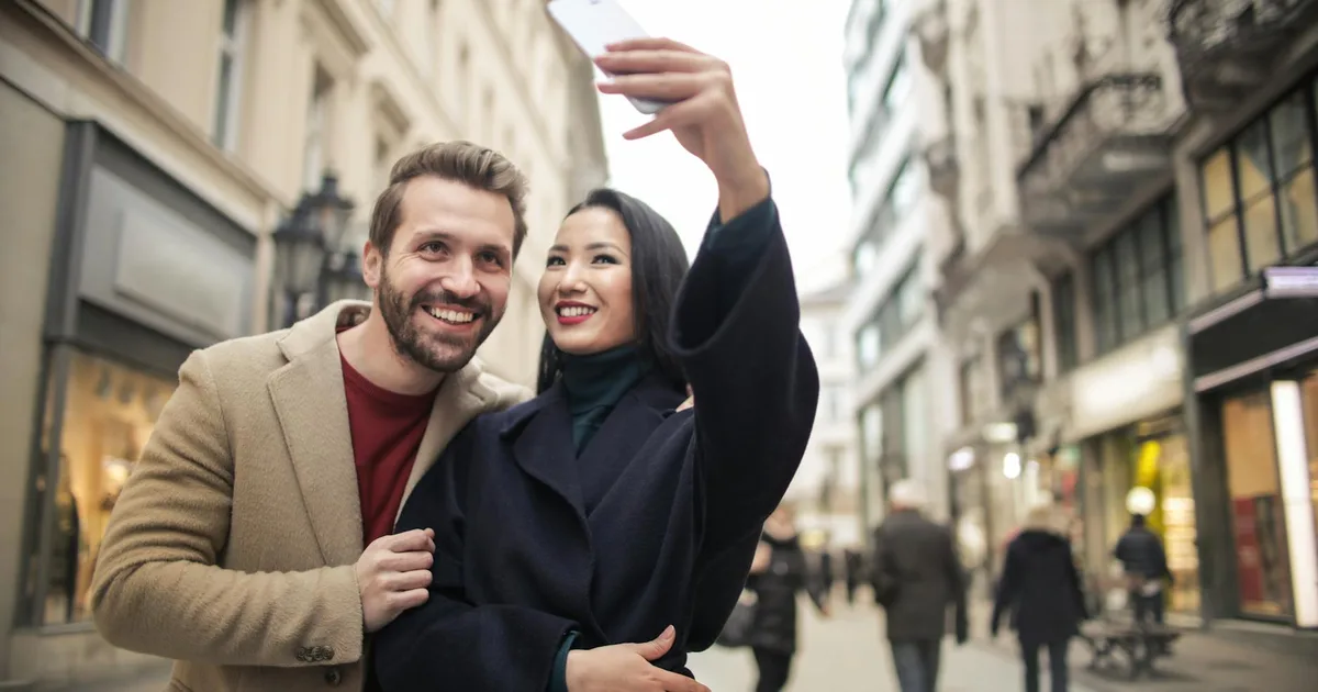 Couple in the city with lights and signs - billboard anniversary surprise idea