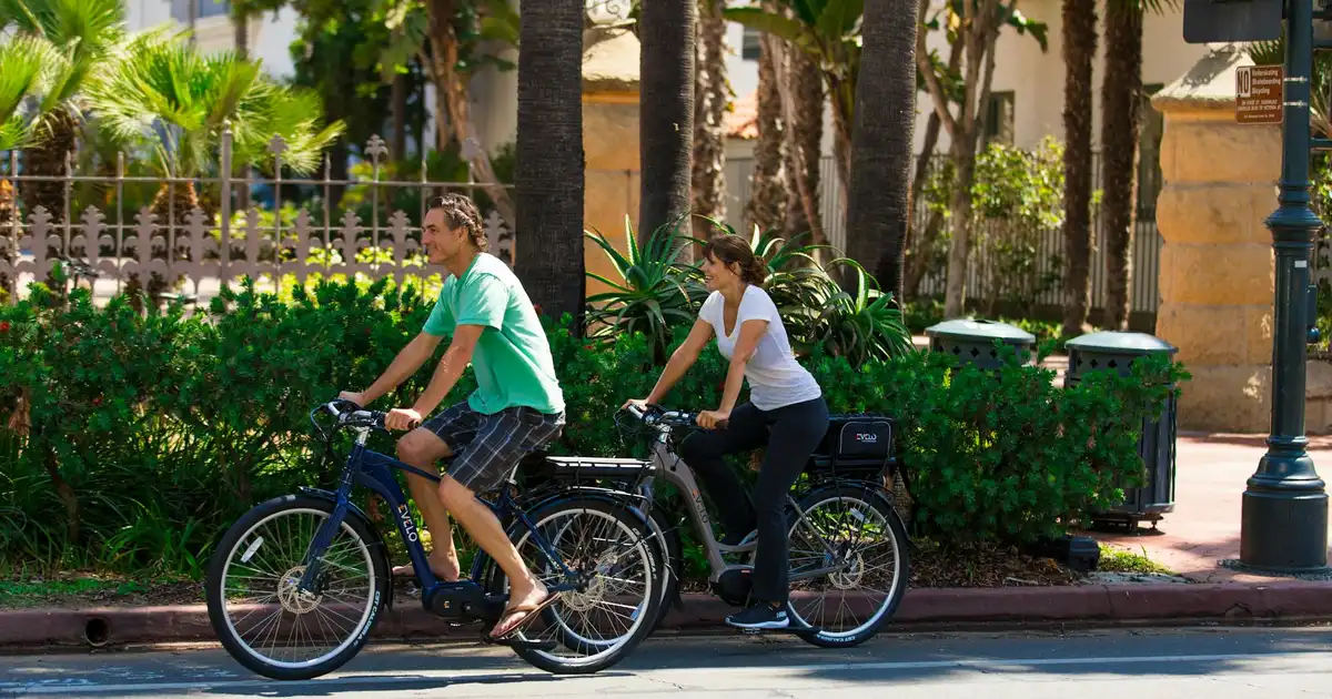 Couple biking through a scenic park on an active date