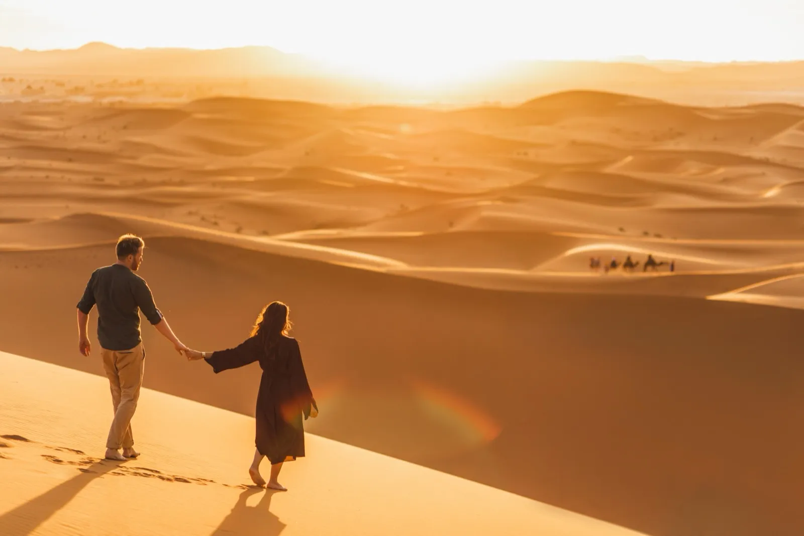 Couple walking through the Sonoran Desert at sunset near Phoenix