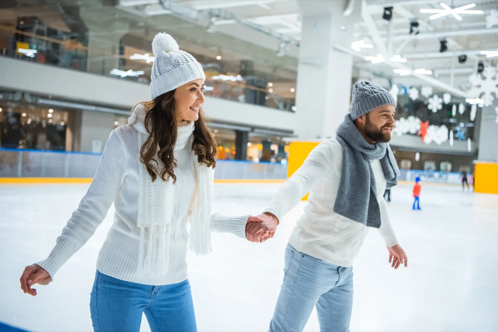 Couple ice skating hand-in-hand at Lake of the Isles in Minneapolis winter