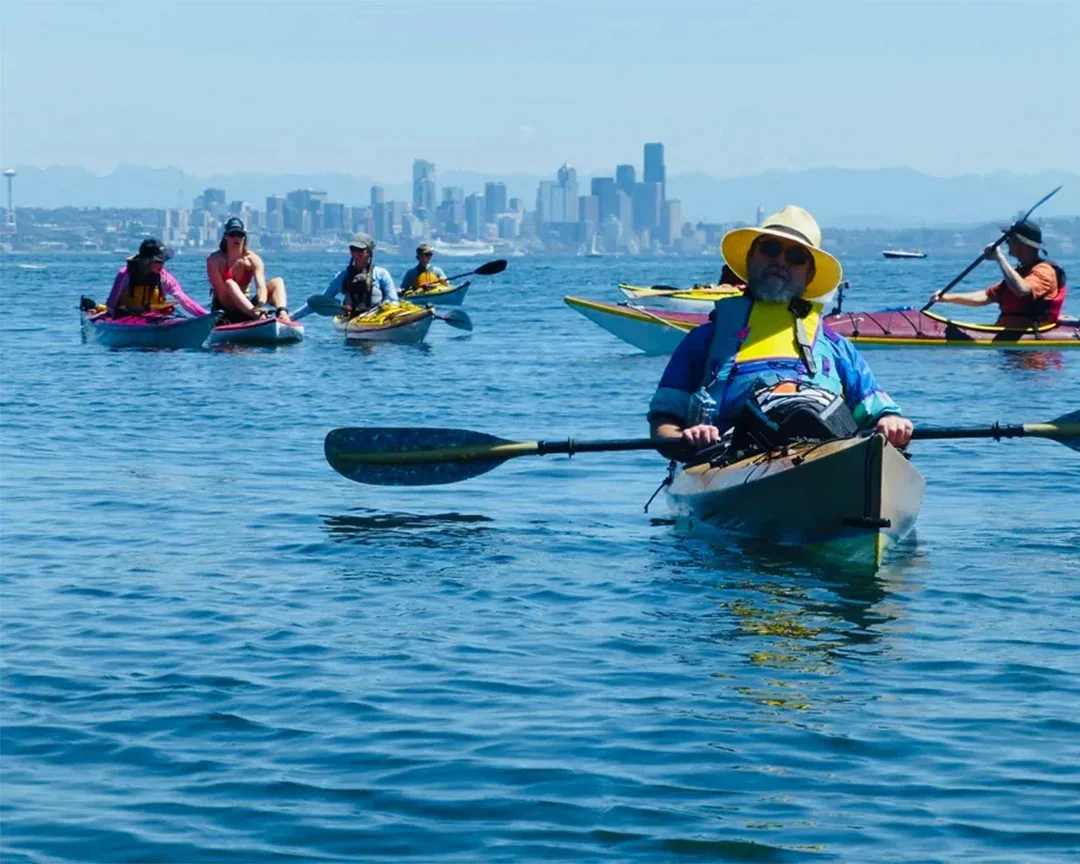 Woman enjoying ice cream on Lake Union cruise with Seattle skyline in background