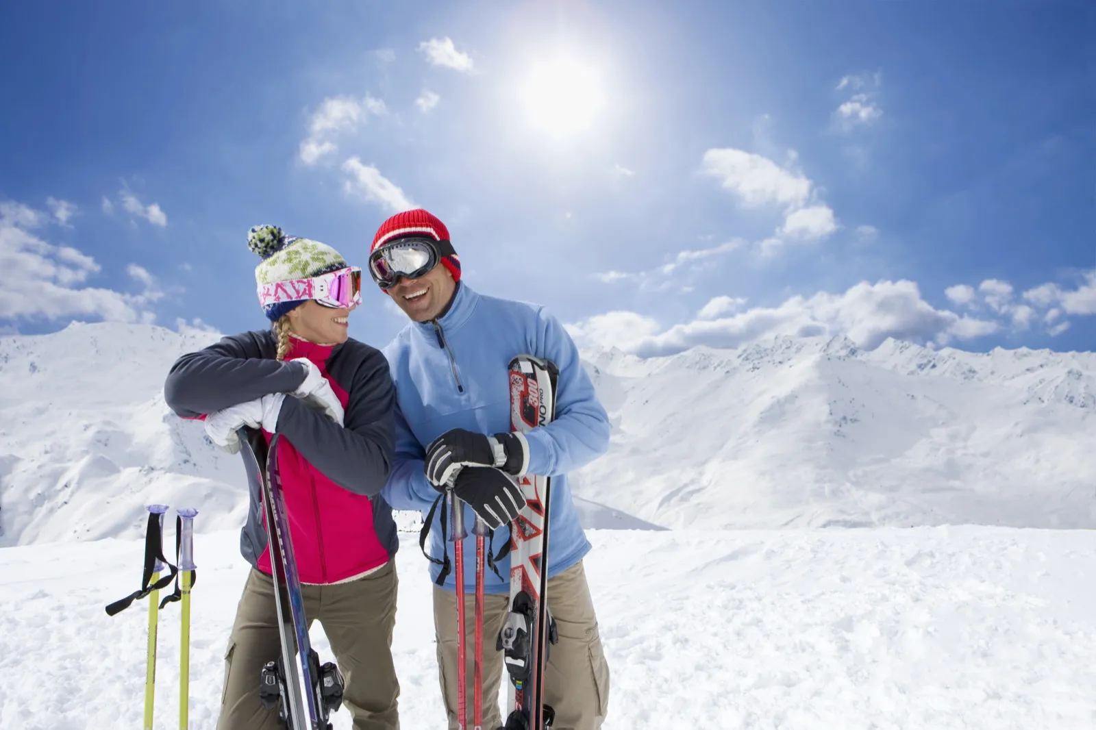 Couple holding skis at a Colorado mountain resort near Denver