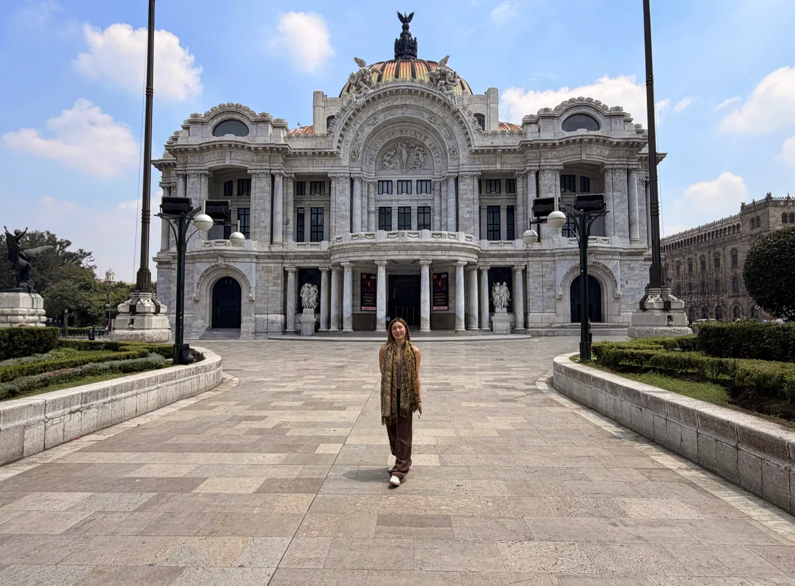 The white marble facade and colored dome of the Palacio de Bellas Artes in Mexico City