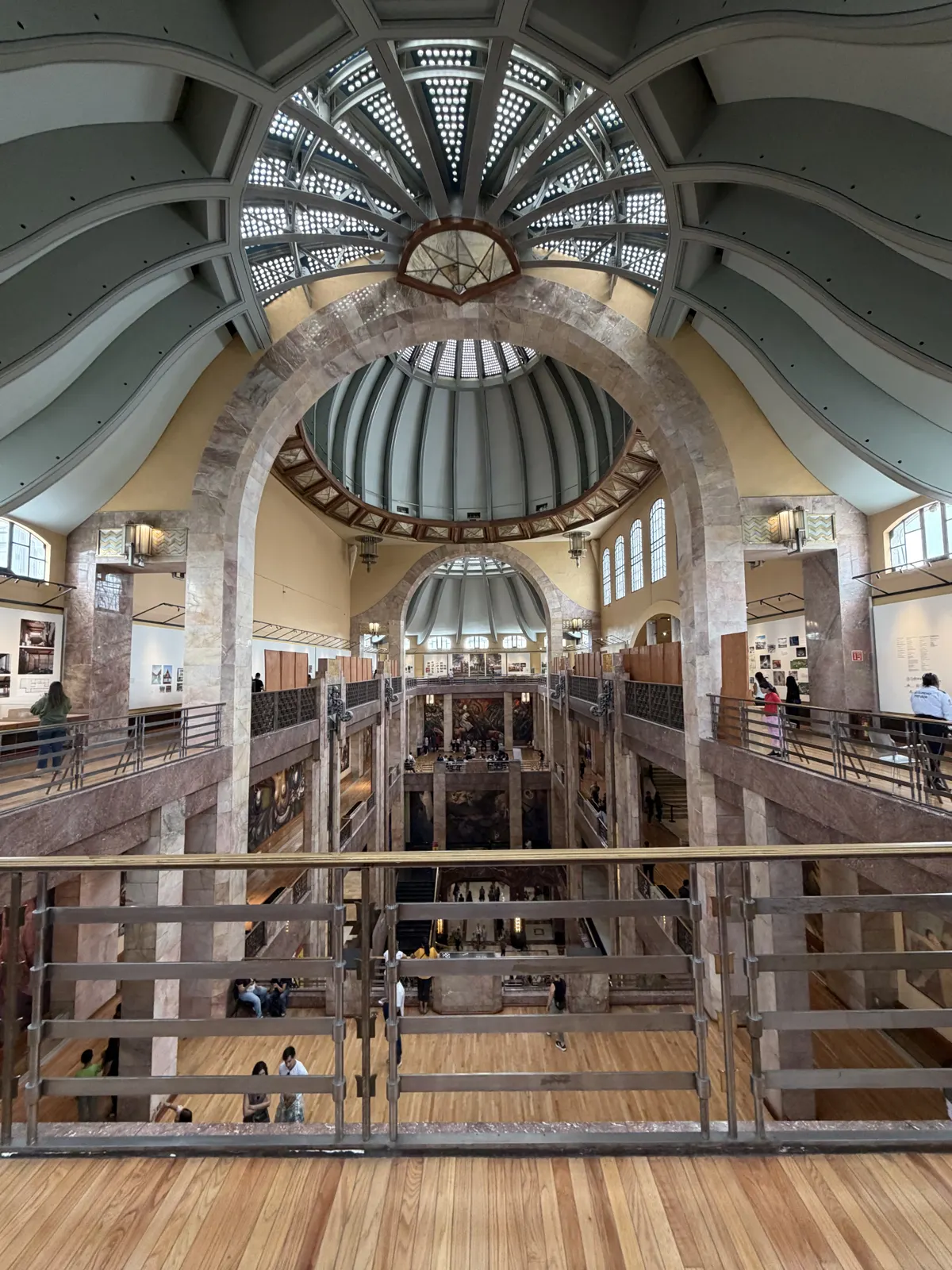 The art deco interior atrium and dome of the Palacio de Bellas Artes seen from an upper floor