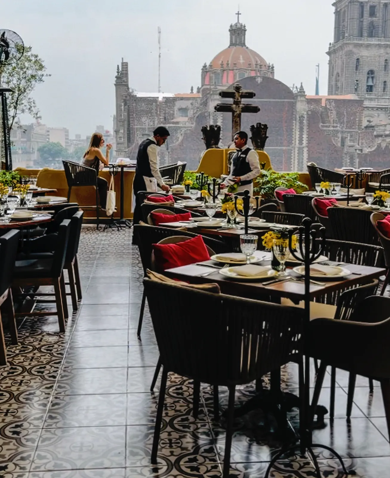 The rooftop terrace at La Casa de las Sirenas set for service with the Metropolitan Cathedral behind it