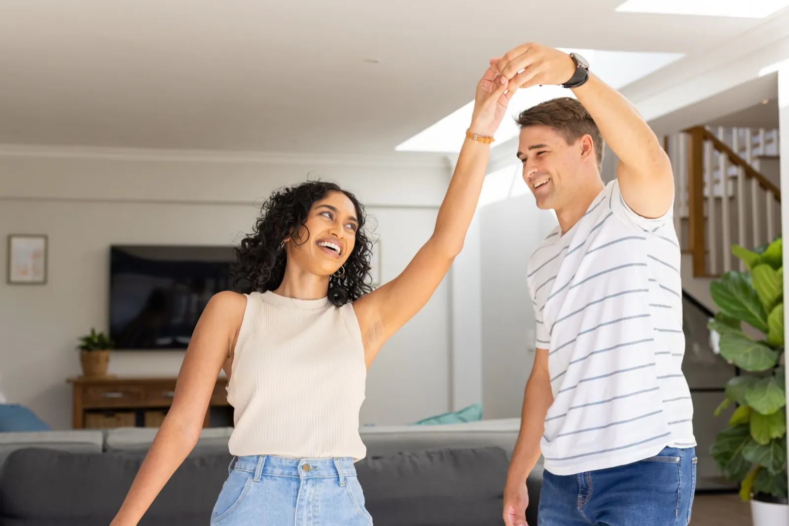 Couple slow dancing in the kitchen for an at-home date night